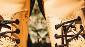 Person trägt gelbe Stiefel mit Löwenzahn und hofft auf Besserung ihrer diabetischen Polyneuropathie.